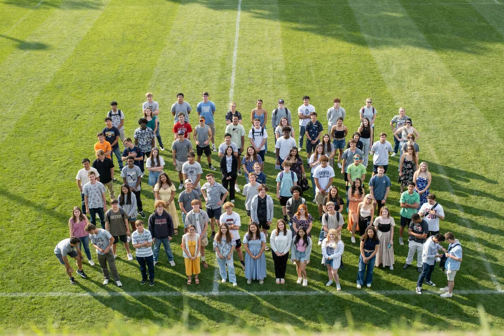 Large student group photographed on the school field.