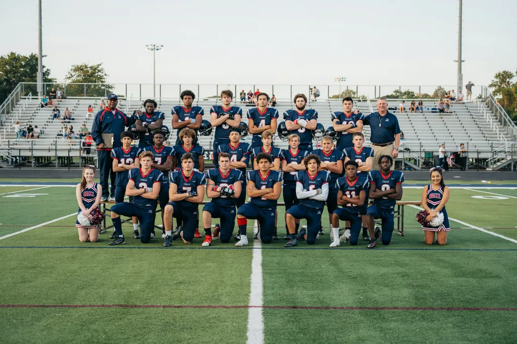 A high school team group photo on the field.